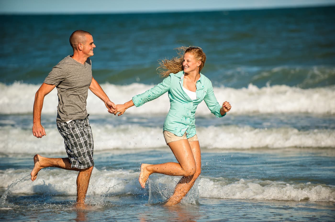 Couple running in the waves